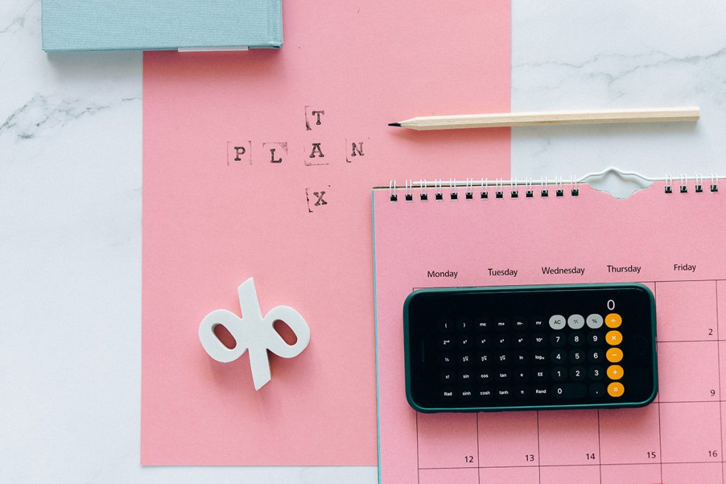 A picture of a pink calendar that reads "tax plan".